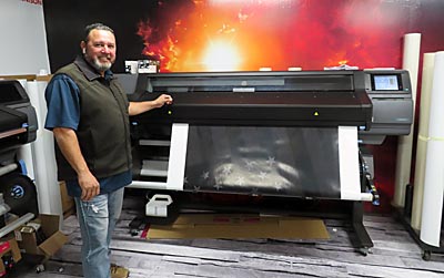 Andrew Napoleon shows one of the machines that prints the vinyl.