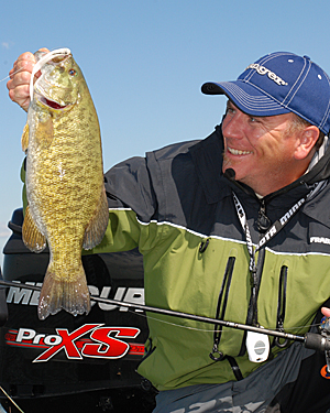 To catch smallmouths like the one Joe Balog is admiring anglers need to under seasonal movements of smallmouth bass.