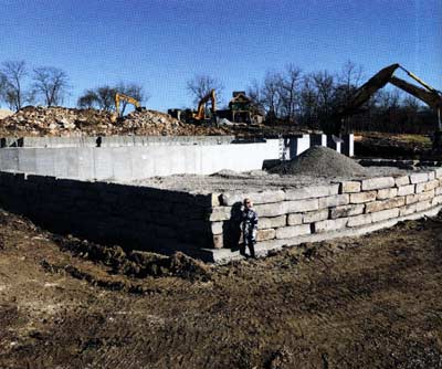 Since part of the plan is to swim in the lake, a retaining wall was built in deep water to bring up an underwater 'beach', next to the guest cabin.