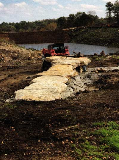 The idea to build a dock from native rock cut out of the dam site turned out fantastic. The whole property has been molded by design.