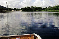 Jack Daugherty's newest property in upstate New York. This shot over the transom of the S.S. Minnow shows the active gravel mining operation and the pristine blue, clear, deep water of the pond, `er lake.