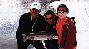 Keeping freshwater going into your pond all winter helps tip the "lid" on the jar keeping oxygen levels high and provides a great place to start angling. Neither ice nor snow can keep the smiles from these kids faces. Photo by Michael J. Mitchell.